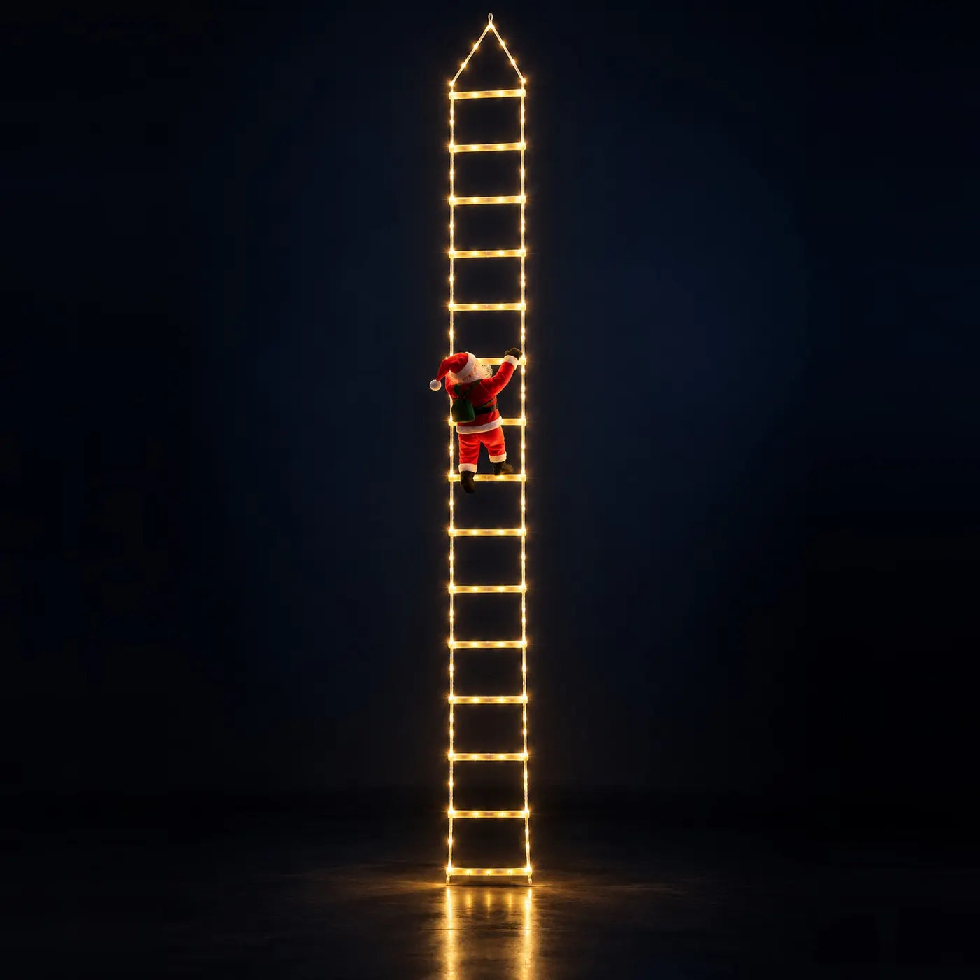 
The full 10 ft ladder lit warm white on a dark studio floor, with the plush Santa climbing it from behind